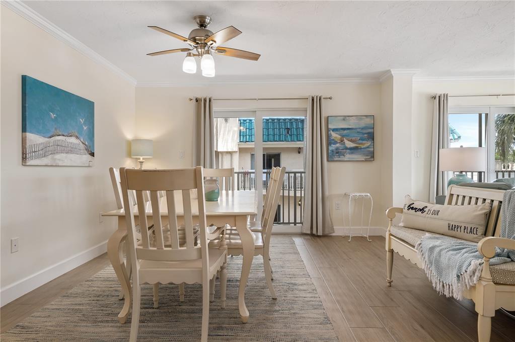 5963 Midnight Pass Road, Unit 332 Sarasota, FL 34242 - Photo 7 of 49 a view of a dining room with furniture and wooden floor
