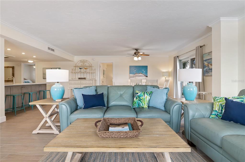 5963 Midnight Pass Road, Unit 332 Sarasota, FL 34242 - Photo 10 of 49 a living room with furniture and a dining table with kitchen view