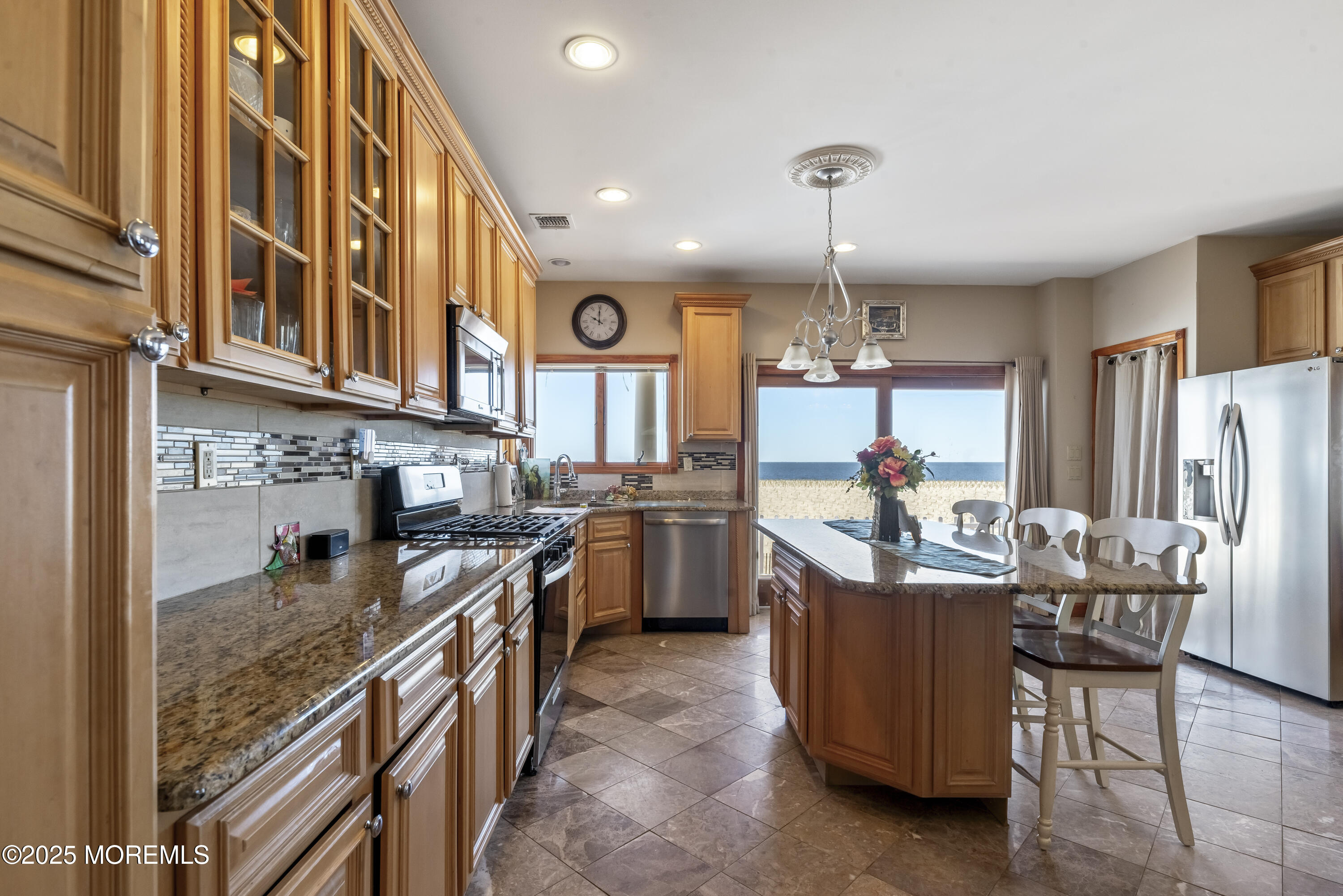 329 Front Street Union Beach, NJ 07735 - Photo 11 of 51 a kitchen with refrigerator a stove and a kitchen island