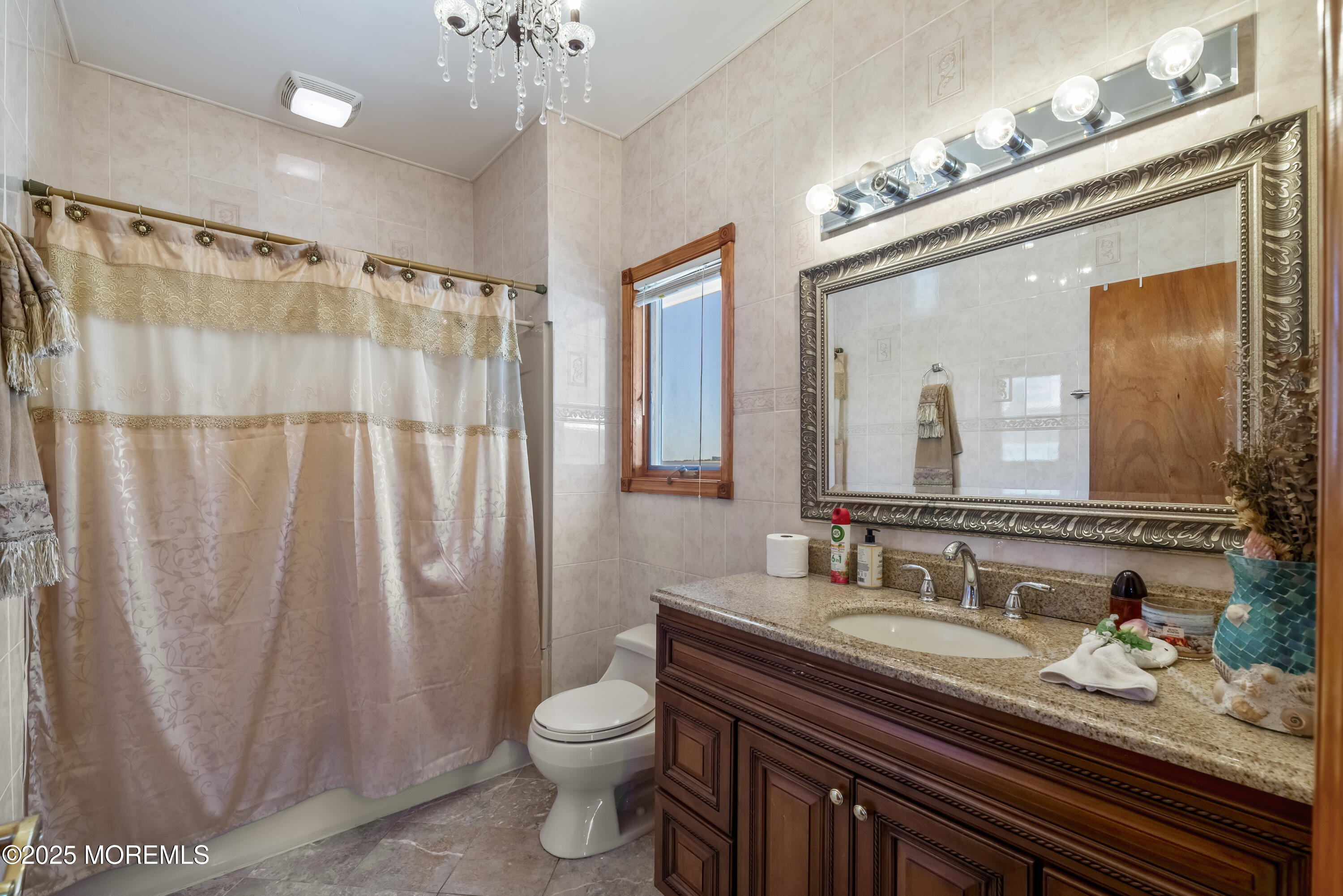 329 Front Street Union Beach, NJ 07735 - Photo 13 of 51 a bathroom with a granite countertop sink toilet a mirror a vanity and shower