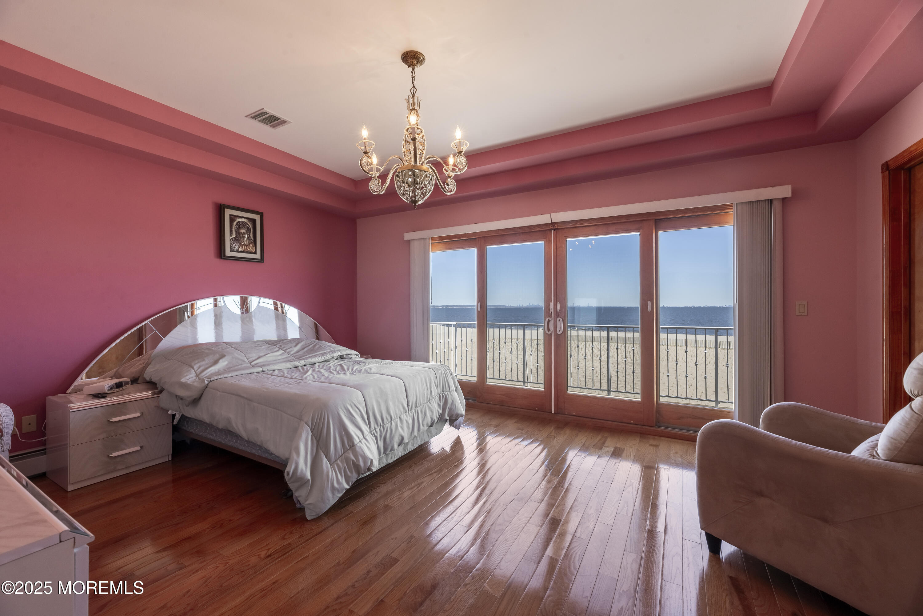 329 Front Street Union Beach, NJ 07735 - Photo 14 of 51 a spacious bedroom with a bed and wooden floor