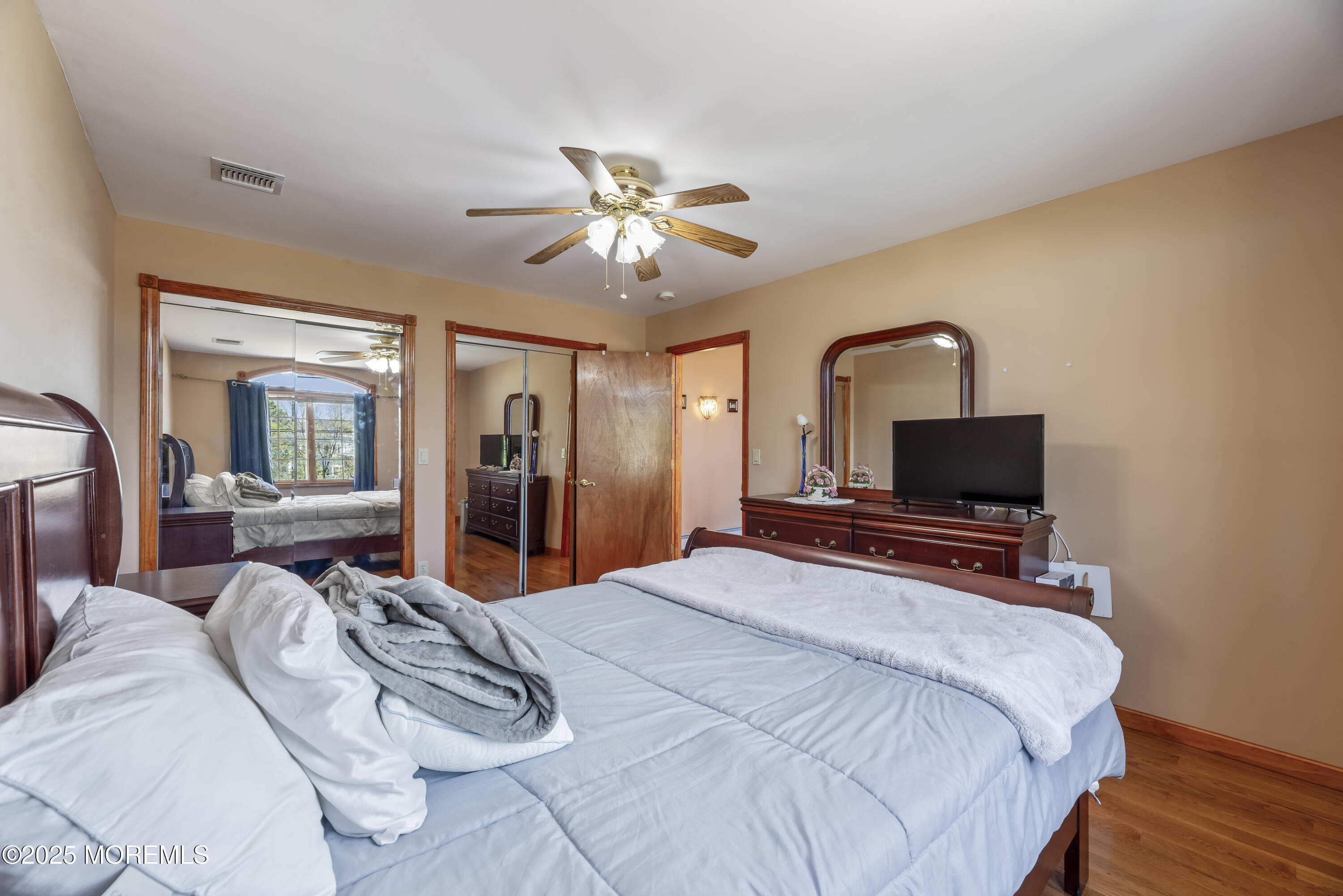329 Front Street Union Beach, NJ 07735 - Photo 21 of 51 a bedroom with a bed and wooden floor