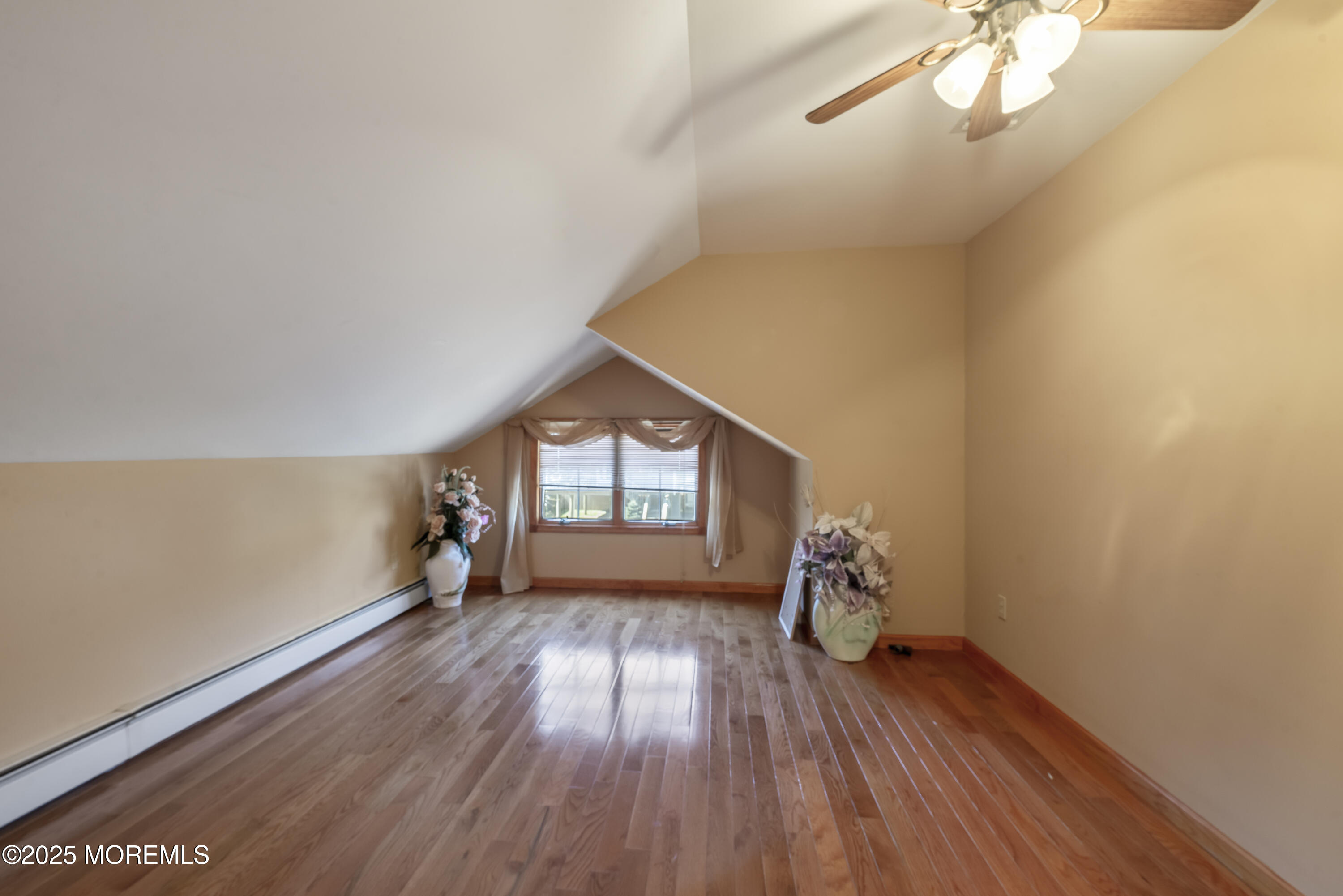 329 Front Street Union Beach, NJ 07735 - Photo 23 of 51 a view of empty room with wooden floor and fan