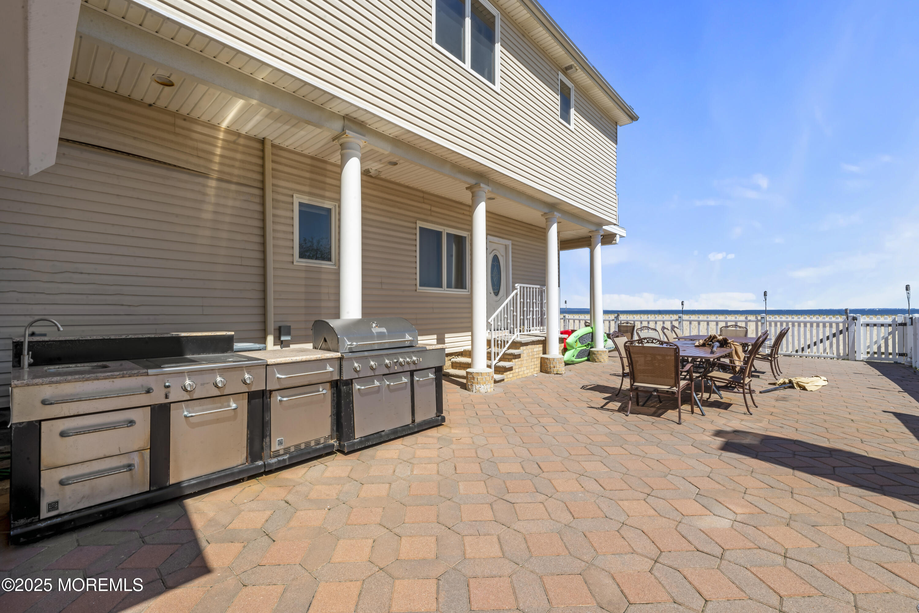 329 Front Street Union Beach, NJ 07735 - Photo 33 of 51 a view of a patio with table and chairs with wooden floor and fence