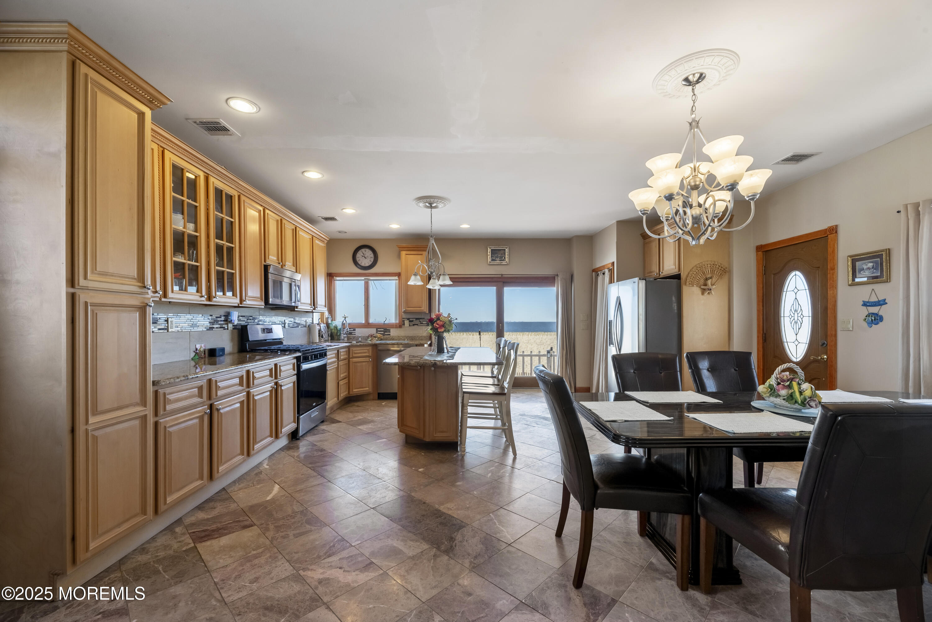 329 Front Street Union Beach, NJ 07735 - Photo 6 of 51 a kitchen with sink refrigerator dining table and chairs