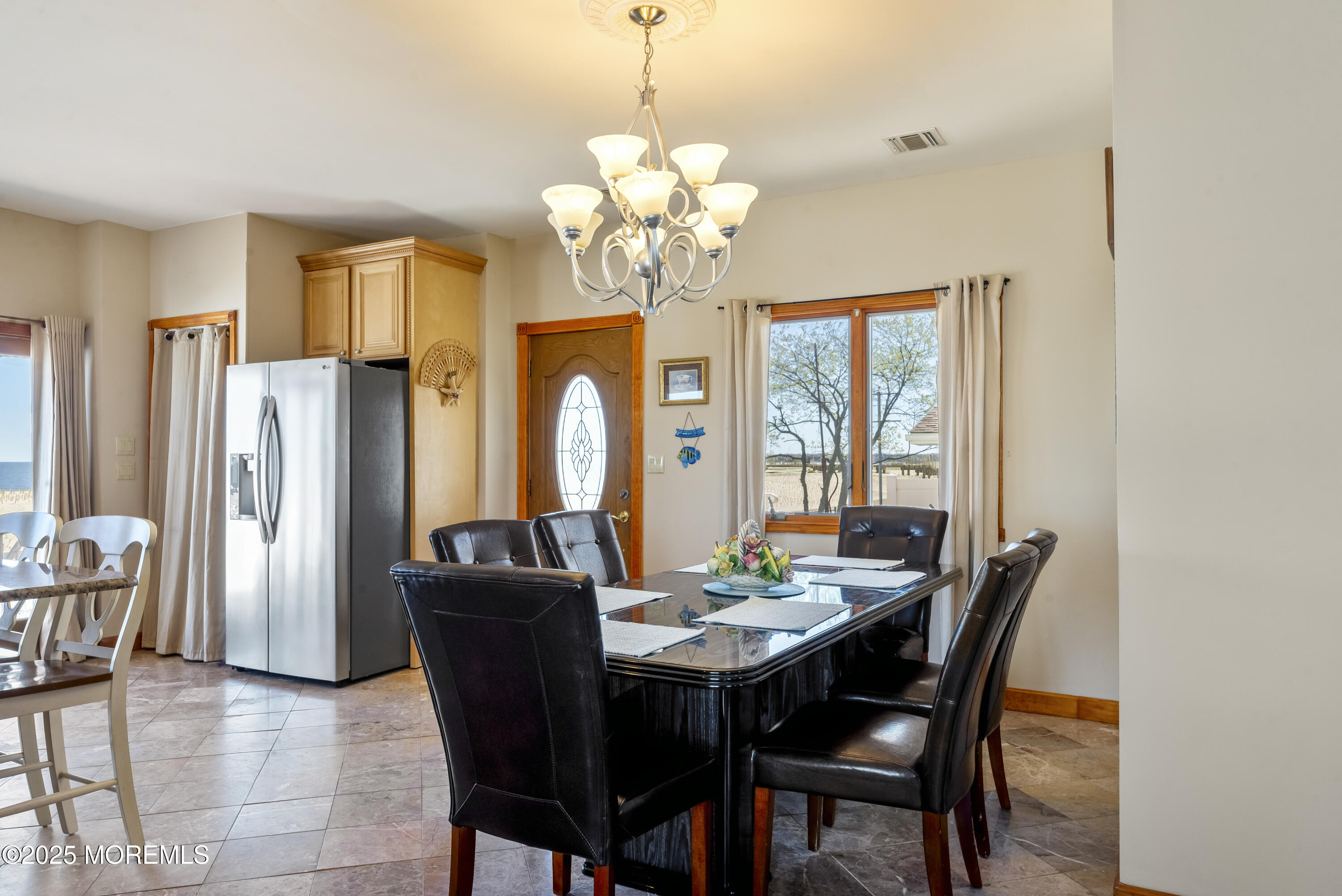 329 Front Street Union Beach, NJ 07735 - Photo 7 of 51 a dining room with furniture a chandelier and window