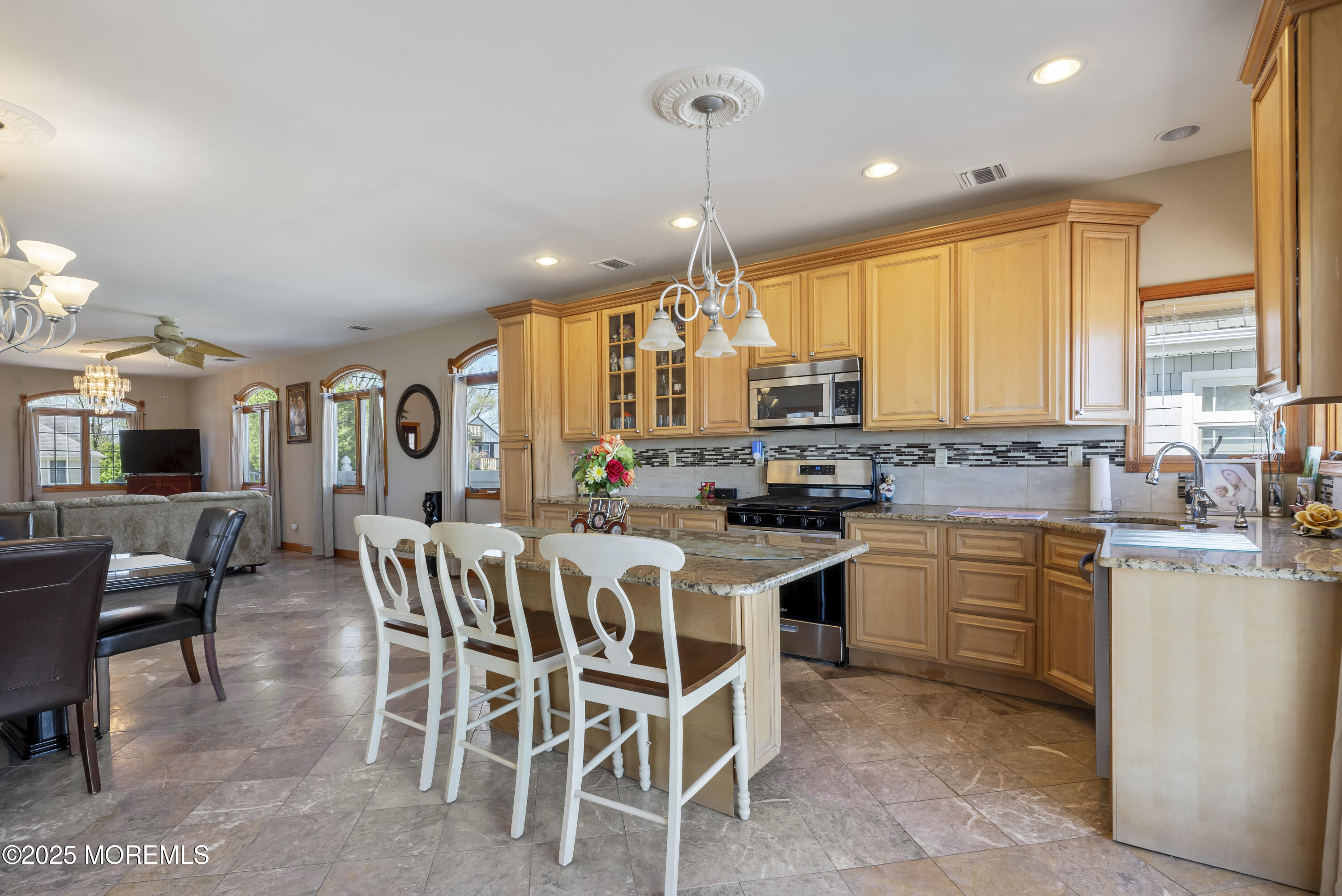 329 Front Street Union Beach, NJ 07735 - Photo 9 of 51 a kitchen with a dining table chairs sink and cabinets
