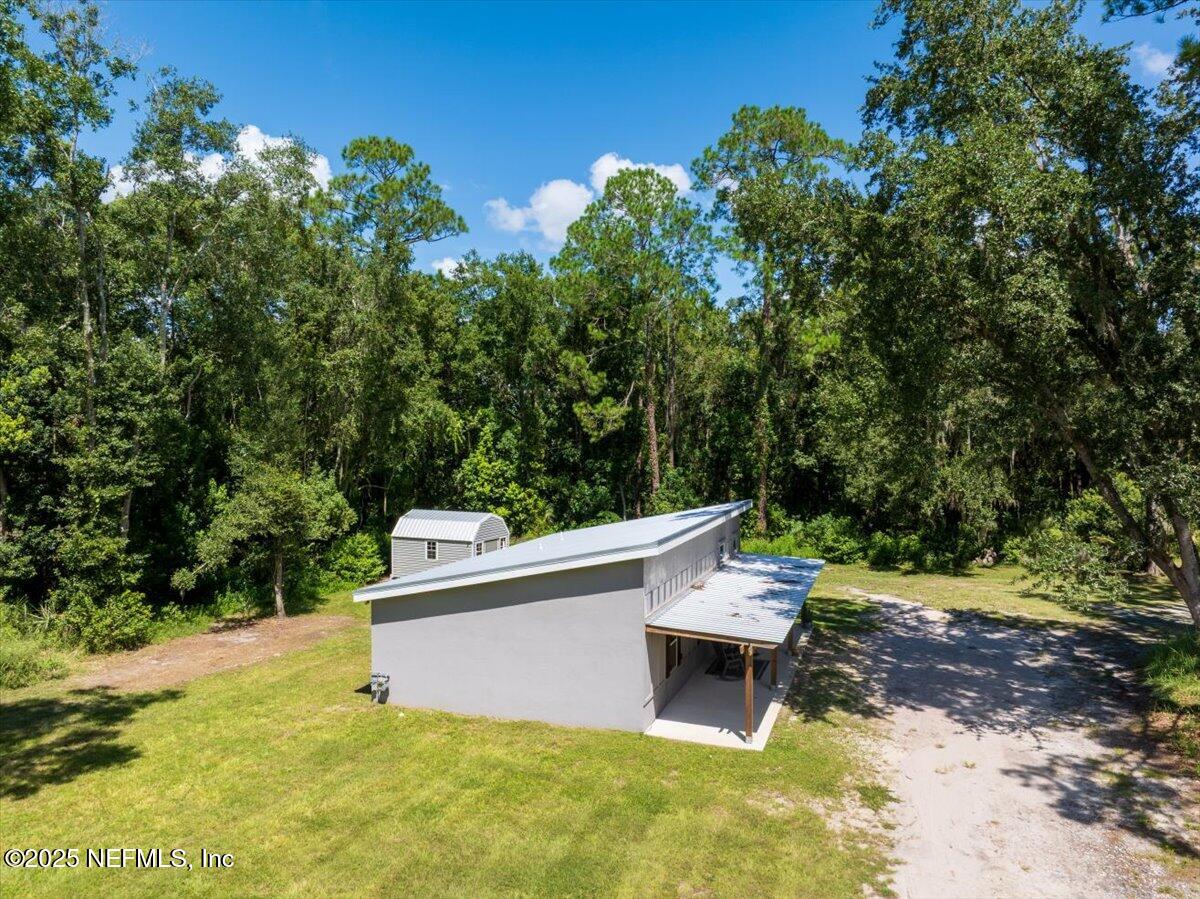 3514 Weaver Road Palatka, FL 32177 - Photo 22 of 30 a backyard of a house with yard and outdoor seating