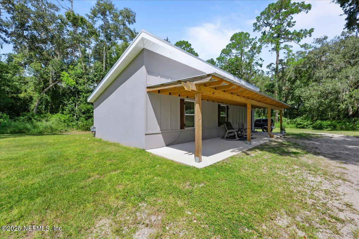 3514 Weaver Road Palatka, FL 32177 - Photo 4 of 30 a view of a house with a yard patio and a garden