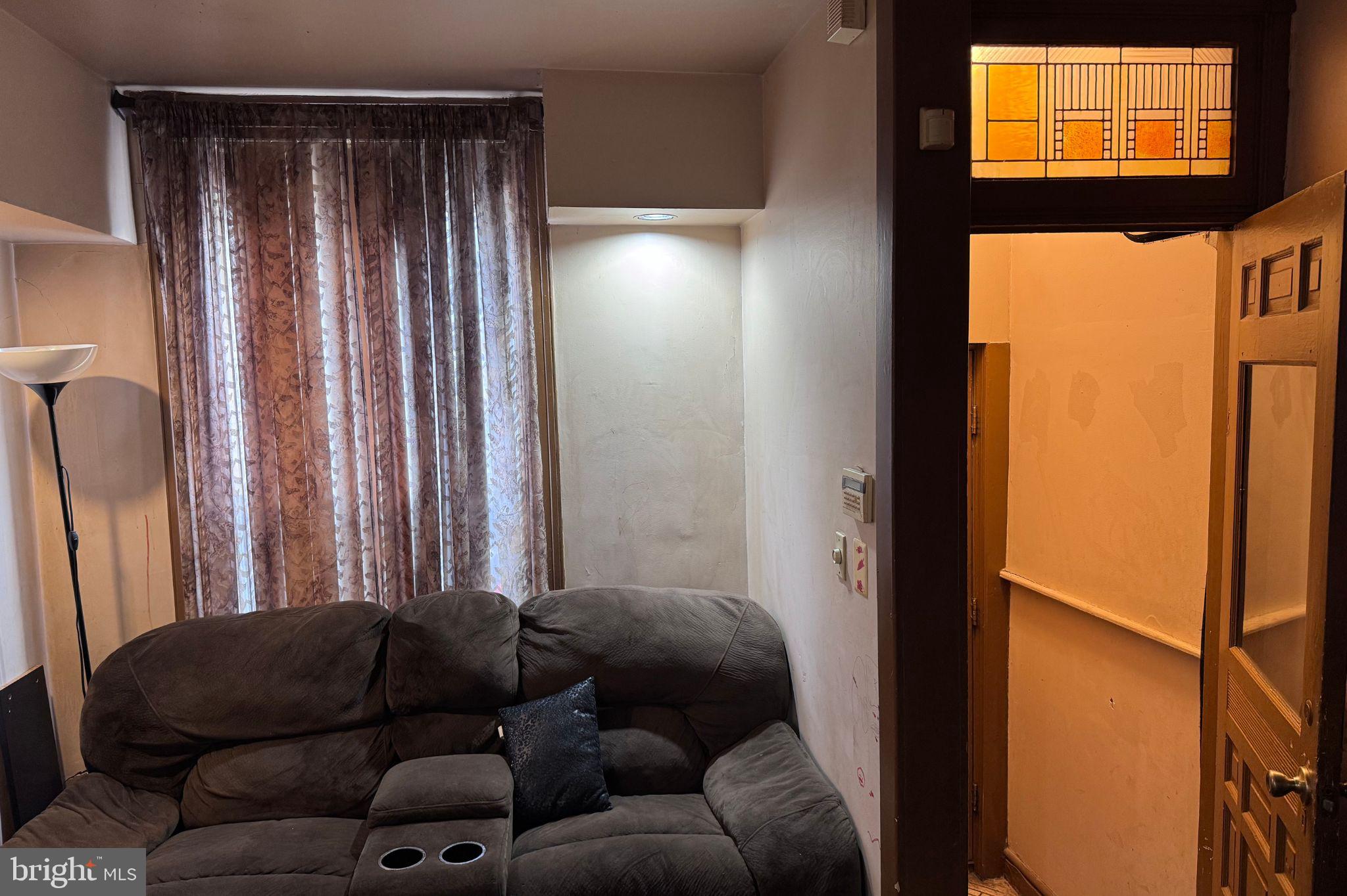 120 North Glover Street Baltimore, MD 21224 - Photo 4 of 8 a living room with furniture and a window