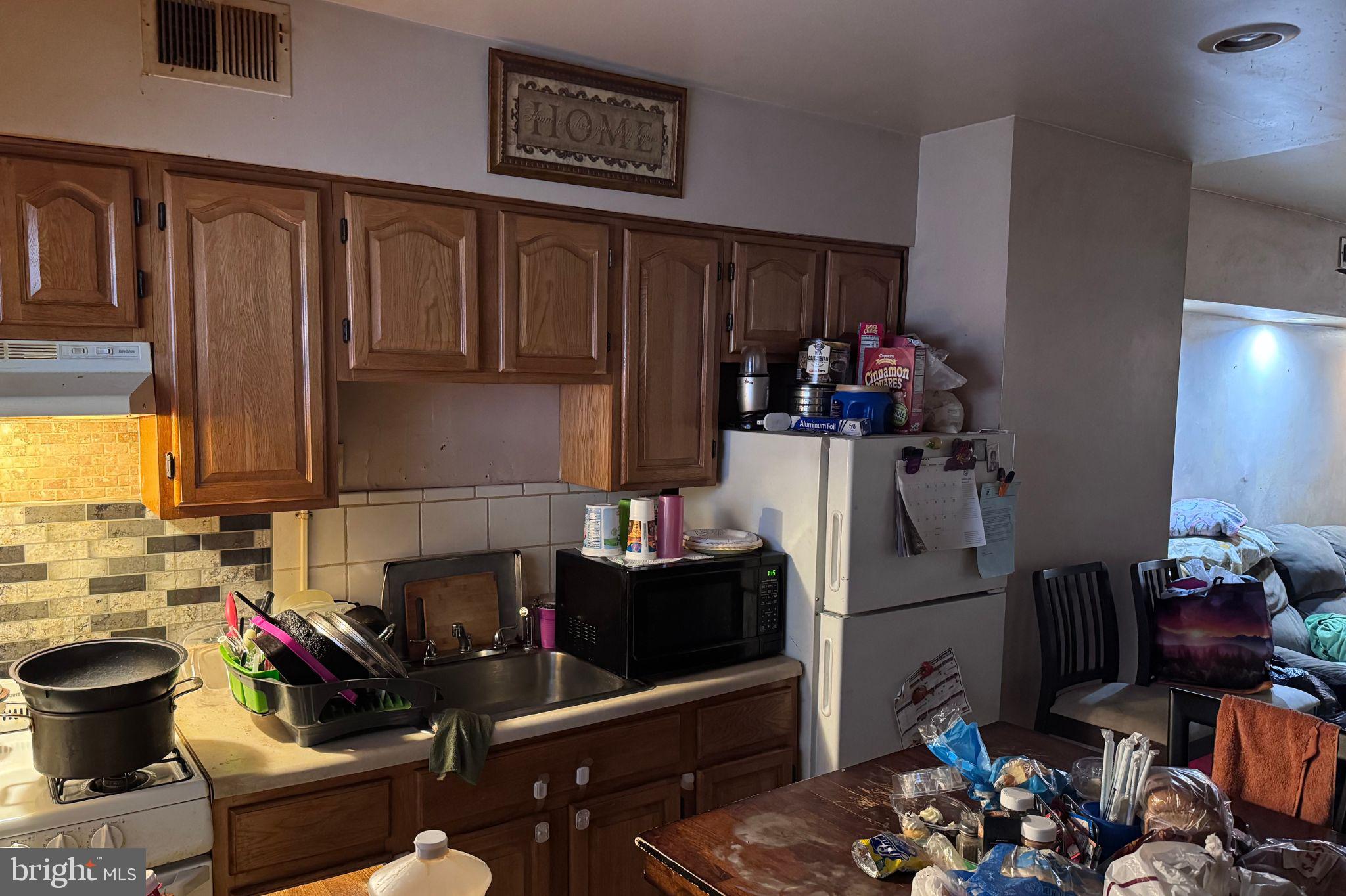 120 North Glover Street Baltimore, MD 21224 - Photo 6 of 8 a kitchen with a sink and a stove top oven