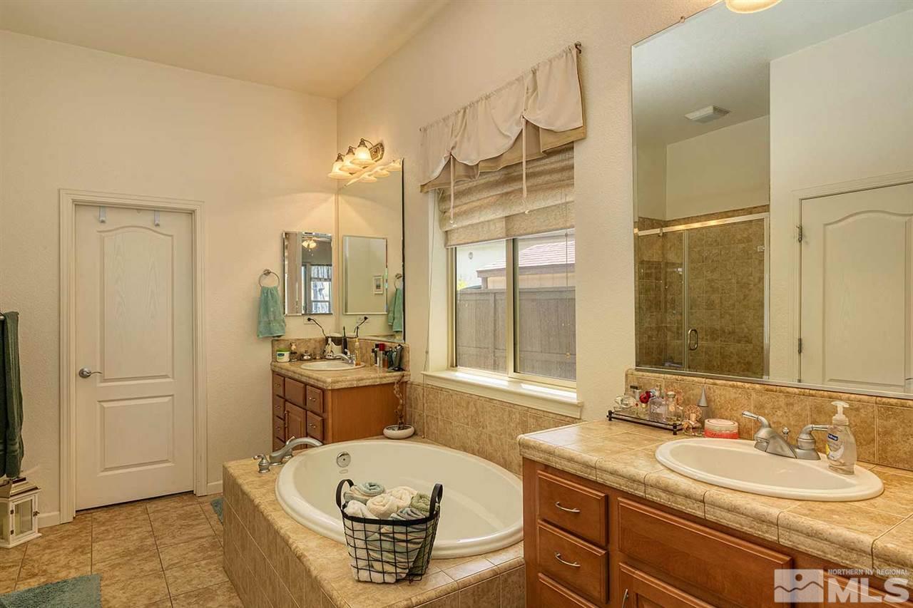 1170 South University Reno, NV 89512 - Photo 12 of 14 a bathroom with a tub sink and mirror