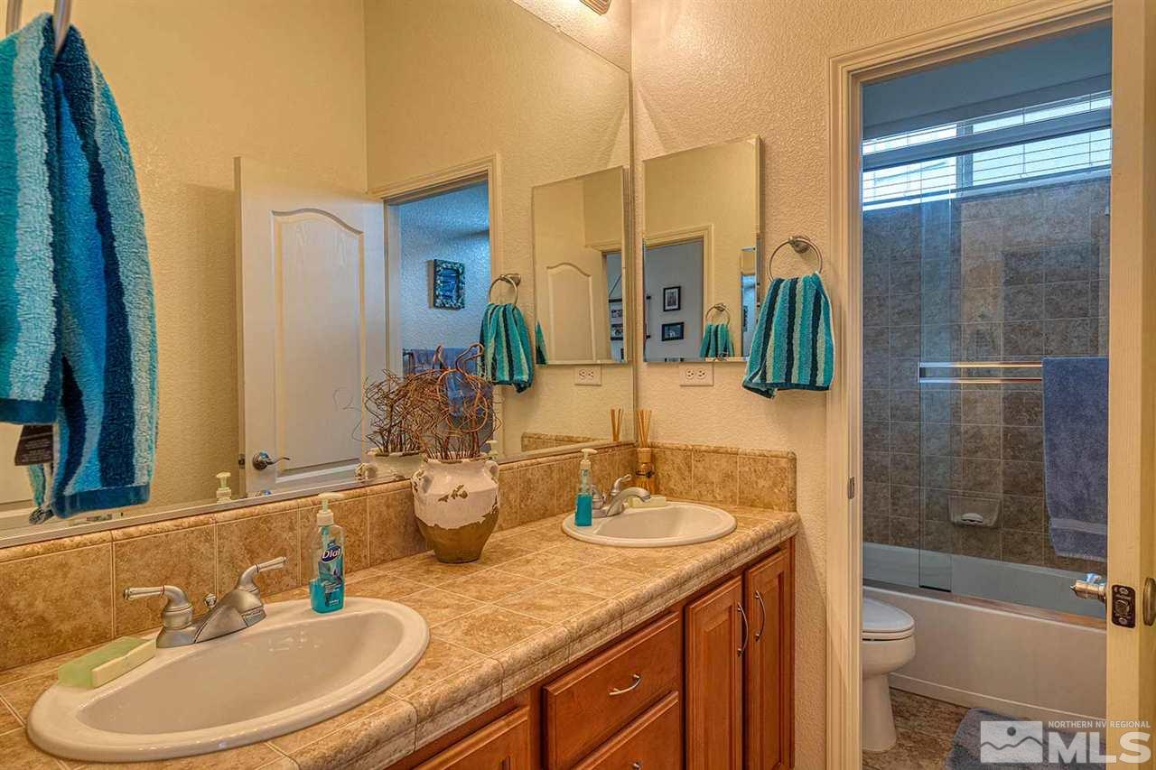 1170 South University Reno, NV 89512 - Photo 4 of 14 a bathroom with a granite countertop sink toilet and shower