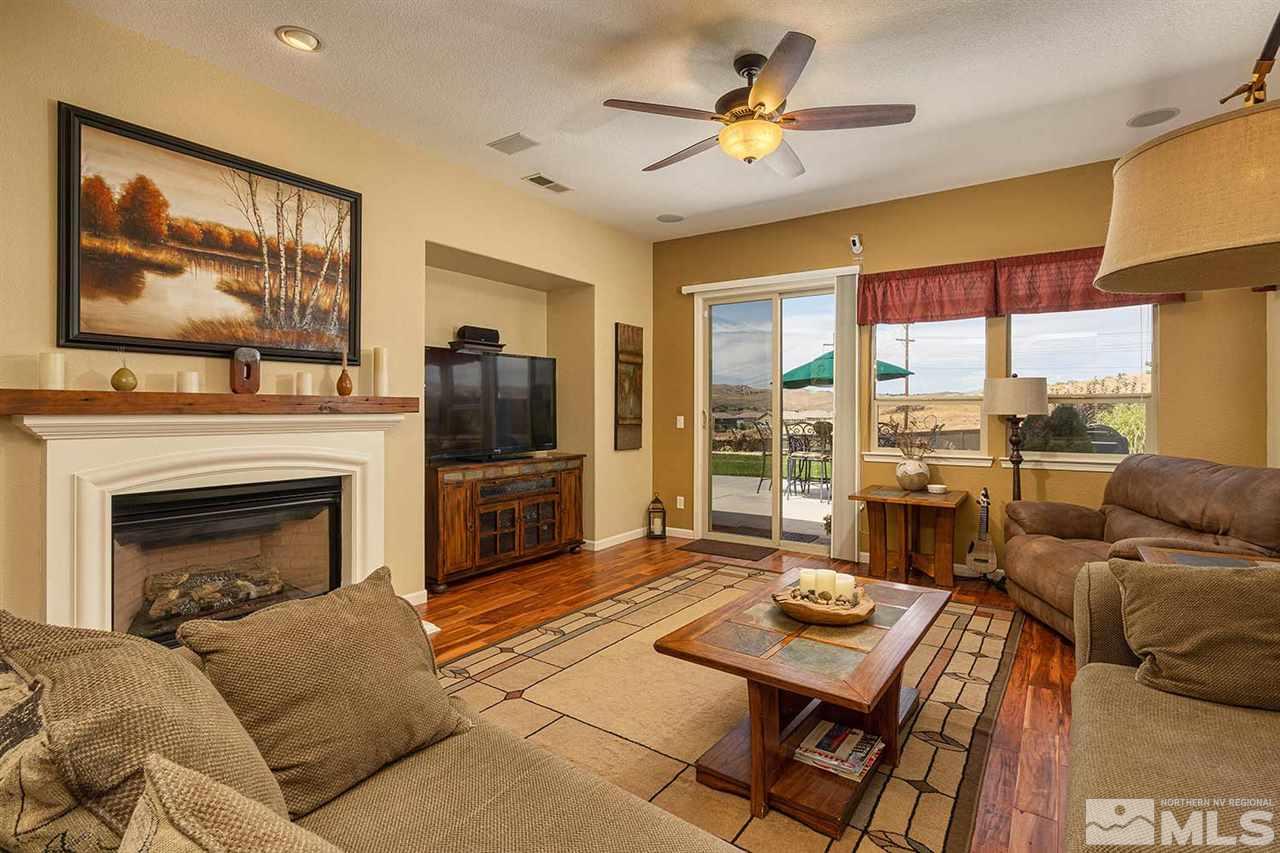 1170 South University Reno, NV 89512 - Photo 8 of 14 a living room with furniture a flat screen tv and a fireplace