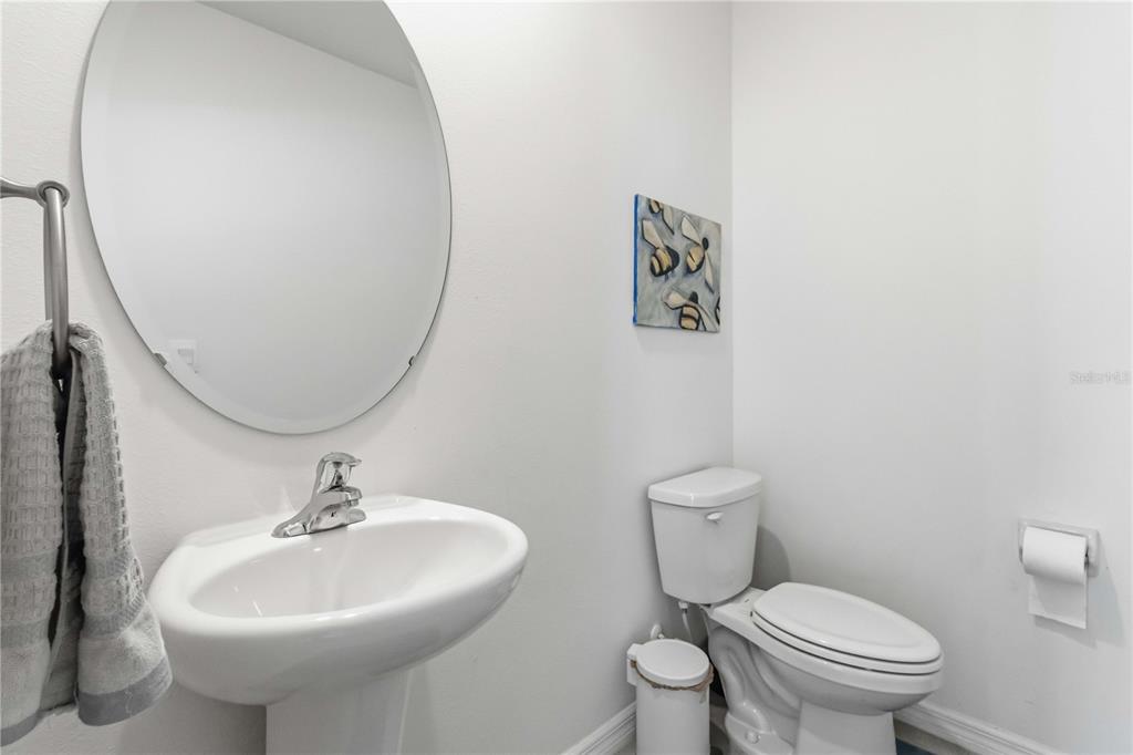 8354 Hardy Bay Loop Wesley Chapel, FL 33545 - Photo 11 of 32 a bathroom with a toilet sink and mirror