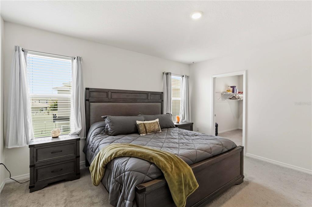 8354 Hardy Bay Loop Wesley Chapel, FL 33545 - Photo 12 of 32 a bedroom with a bed and a window
