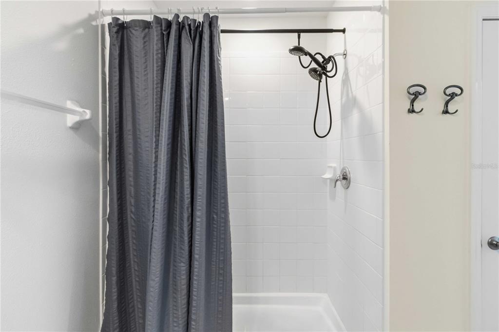 8354 Hardy Bay Loop Wesley Chapel, FL 33545 - Photo 15 of 32 a bathroom with a shower and a bath tub