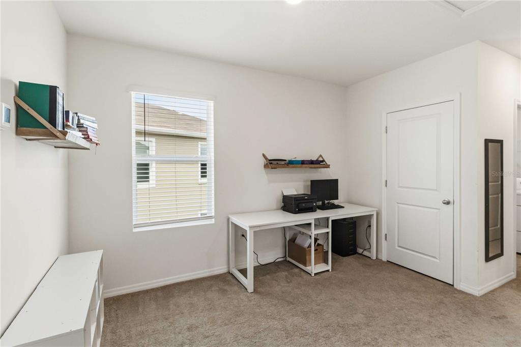 8354 Hardy Bay Loop Wesley Chapel, FL 33545 - Photo 21 of 32 a view of a workspace with furniture and a window