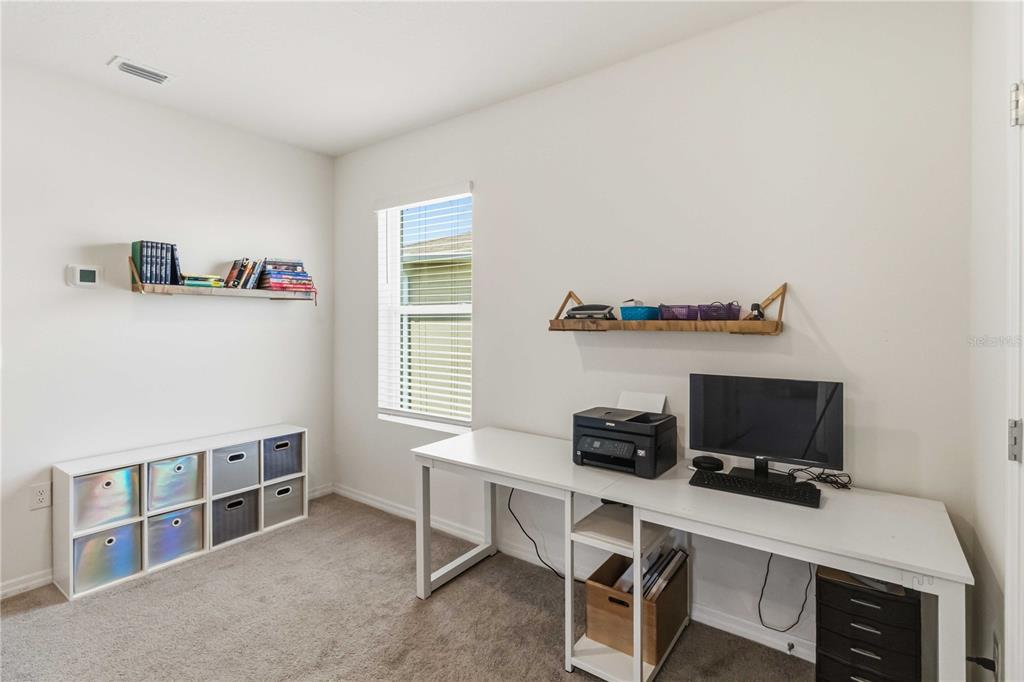 8354 Hardy Bay Loop Wesley Chapel, FL 33545 - Photo 22 of 32 a workspace with furniture and a window