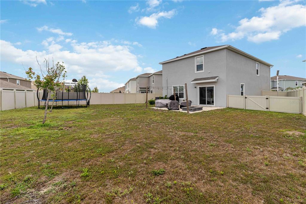 8354 Hardy Bay Loop Wesley Chapel, FL 33545 - Photo 26 of 32 a view of a house with a yard
