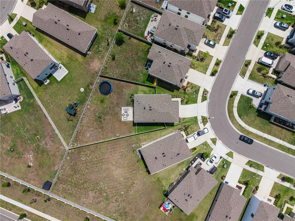 8354 Hardy Bay Loop Wesley Chapel, FL 33545 - Photo 28 of 32 an aerial view of residential houses with outdoor space