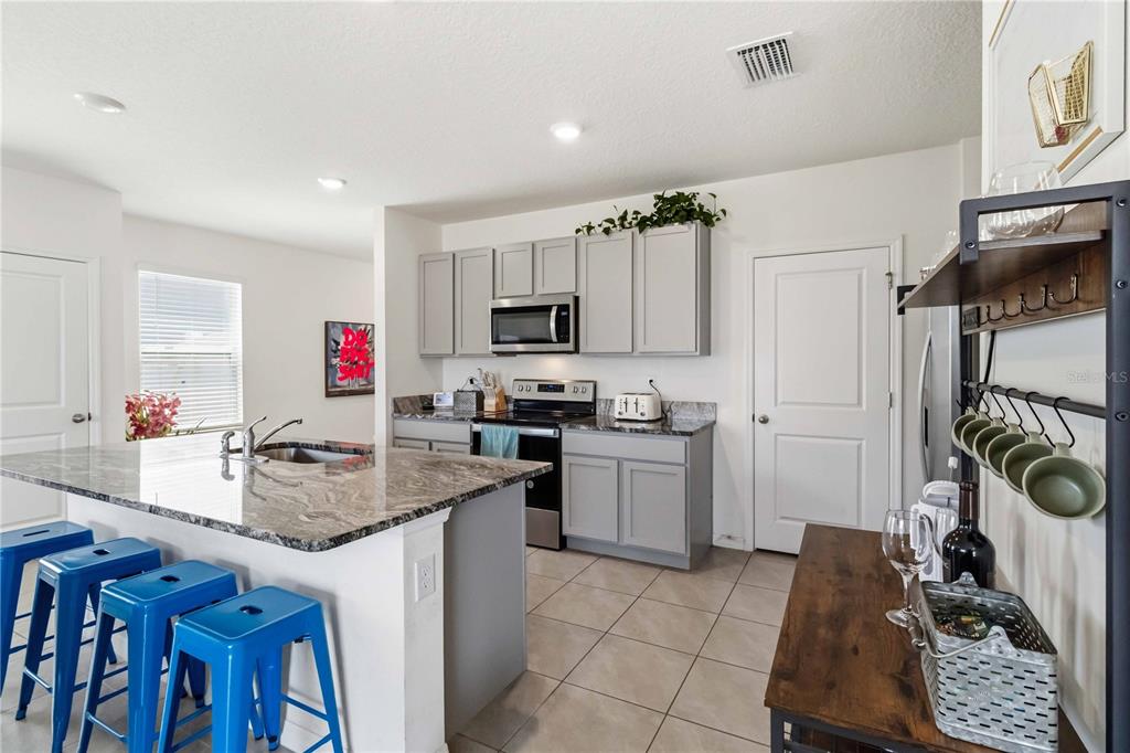 8354 Hardy Bay Loop Wesley Chapel, FL 33545 - Photo 6 of 32 a kitchen with a sink appliances and cabinets