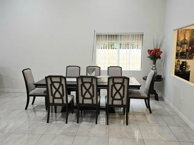 a view of a dining room with furniture and window