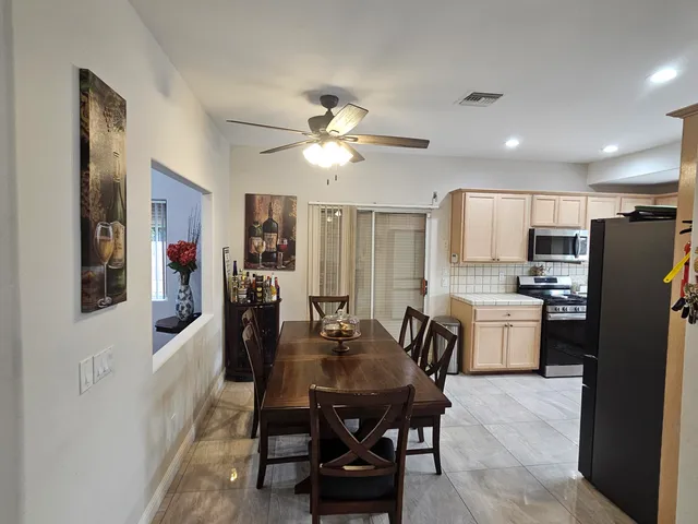 a bathroom with double vanity sinks a toilet a mirror and shower