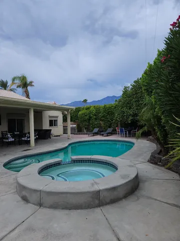 a view of a house with sitting area and garden