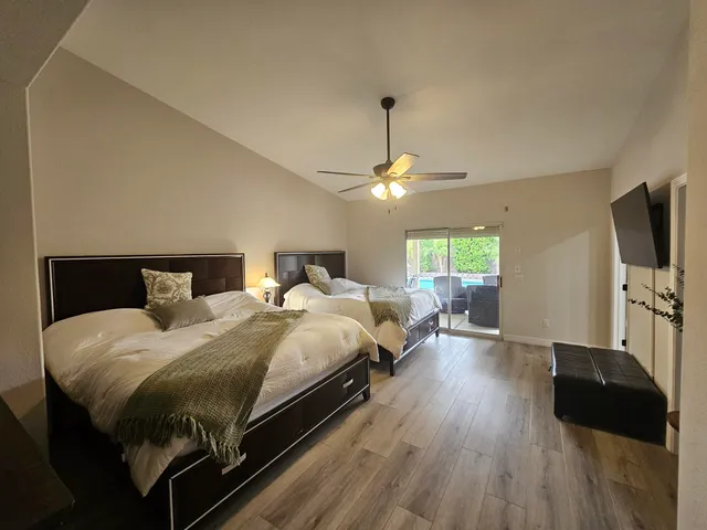 a bedroom with a bed window and a flat screen tv