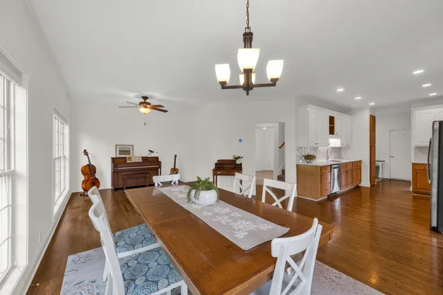 an open kitchen with dining table and appliances