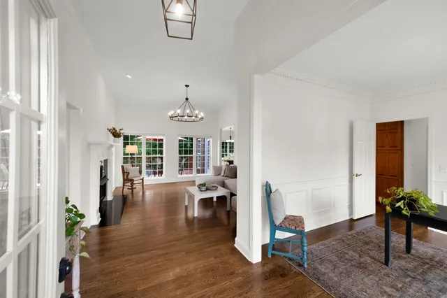a view of a livingroom with furniture hardwood floor and a window