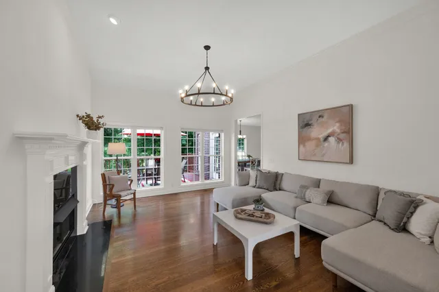 a living room with furniture a dining table and a fireplace