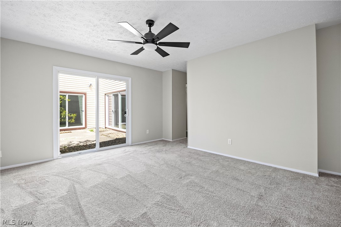 32969 Mills Road North Ridgeville, OH 44039 - Photo 18 of 29 Unfurnished room with light carpet, ceiling fan, and a textured ceiling