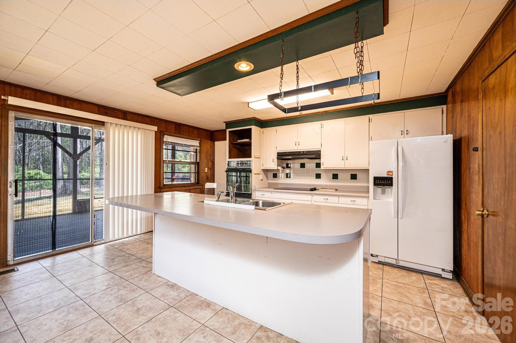 781 23rd Avenue Northeast Hickory, NC 28601 - Photo 21 of 41 a large white kitchen with a large window and stainless steel appliances