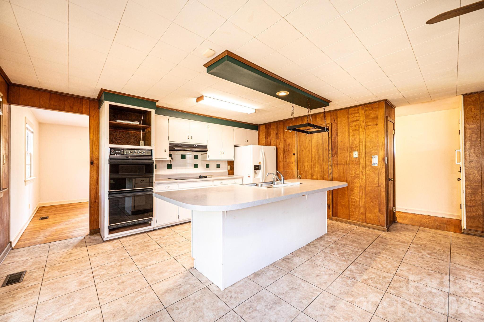 781 23rd Avenue Northeast Hickory, NC 28601 - Photo 22 of 41 a large kitchen with kitchen island granite countertop a large cabinets and a stove top oven