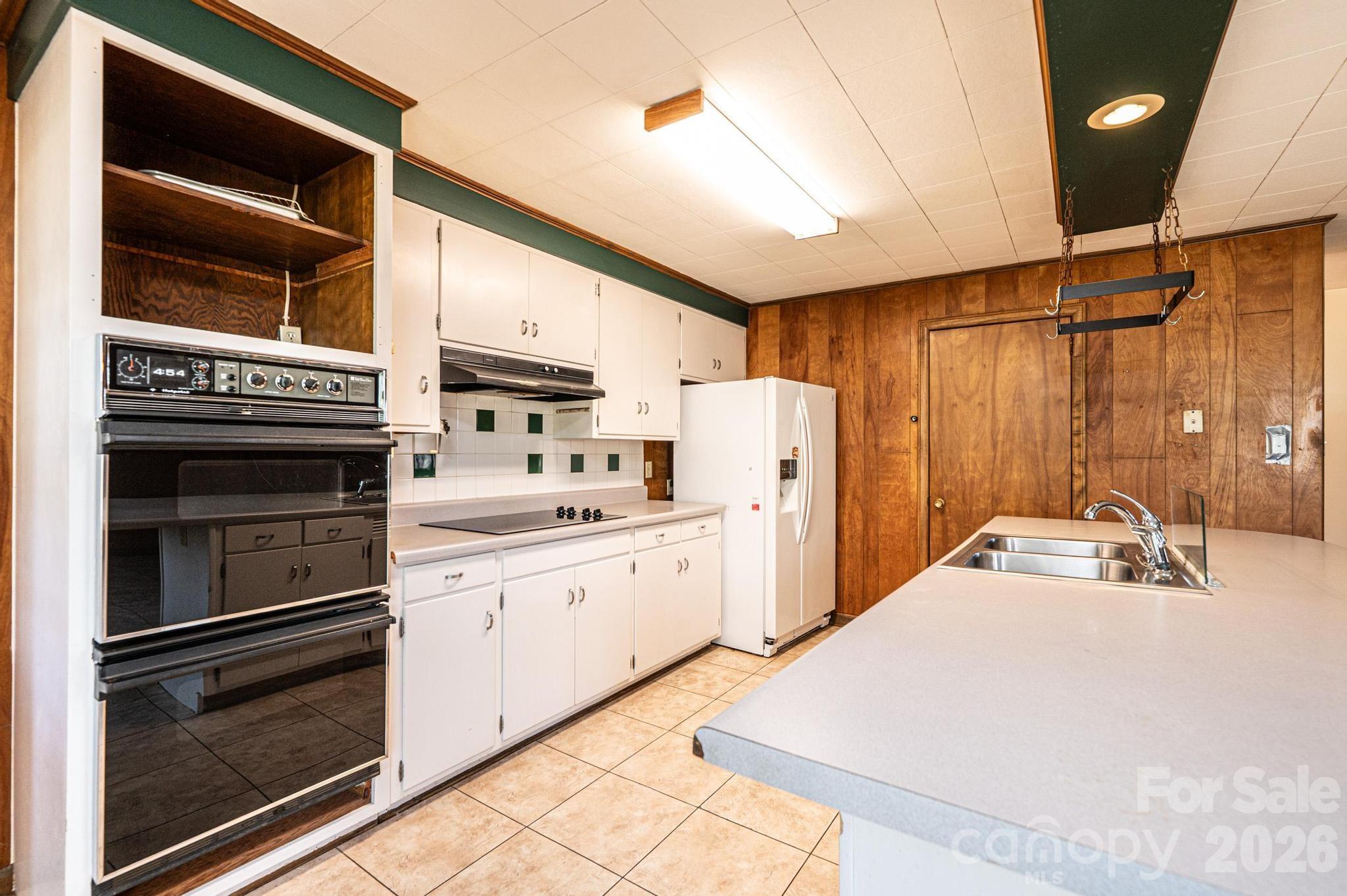 781 23rd Avenue Northeast Hickory, NC 28601 - Photo 23 of 41 a kitchen with refrigerator cabinets and stove top oven