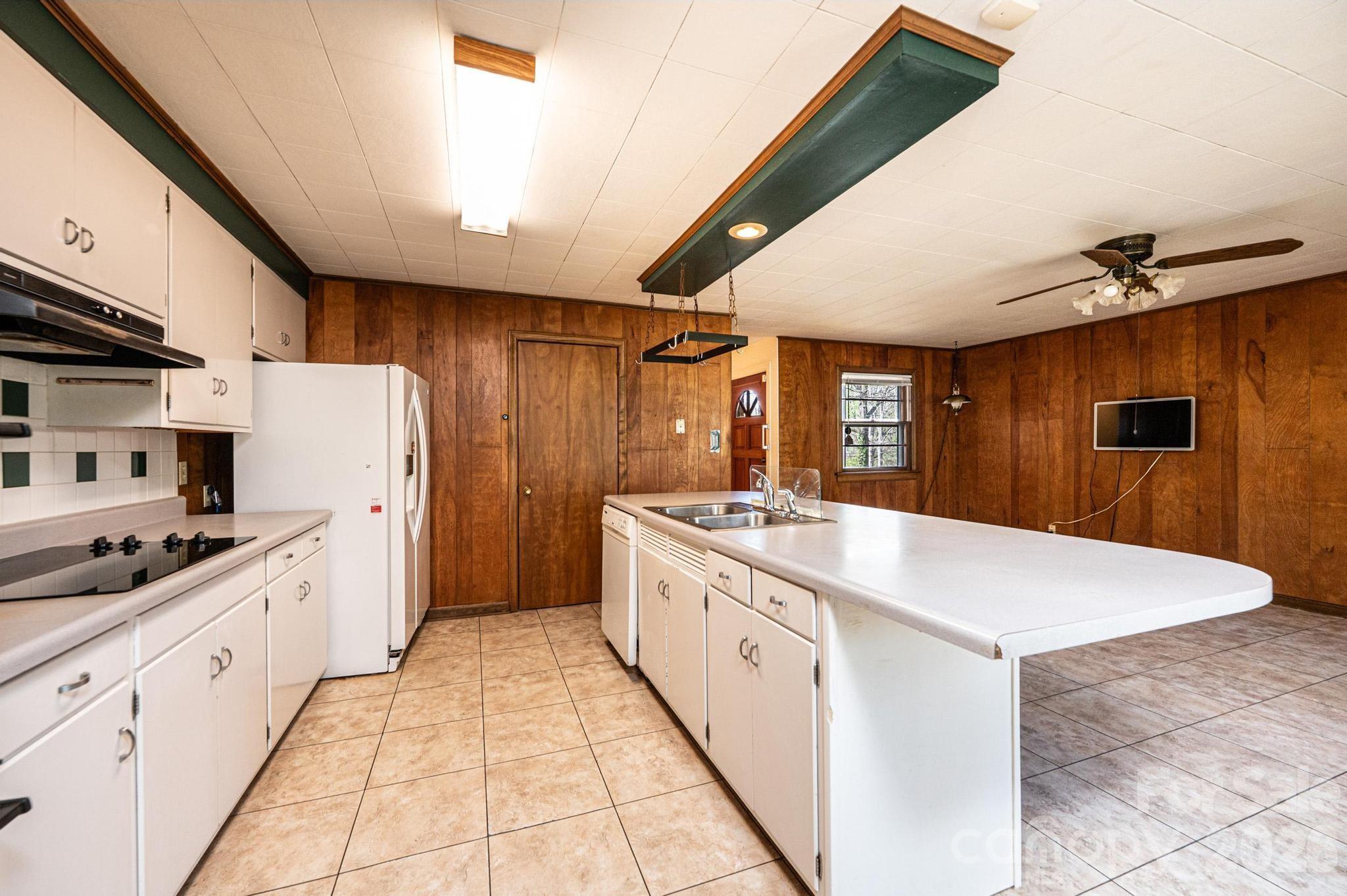 781 23rd Avenue Northeast Hickory, NC 28601 - Photo 25 of 41 a kitchen with white cabinets a sink dishwasher and a stove with wooden floor