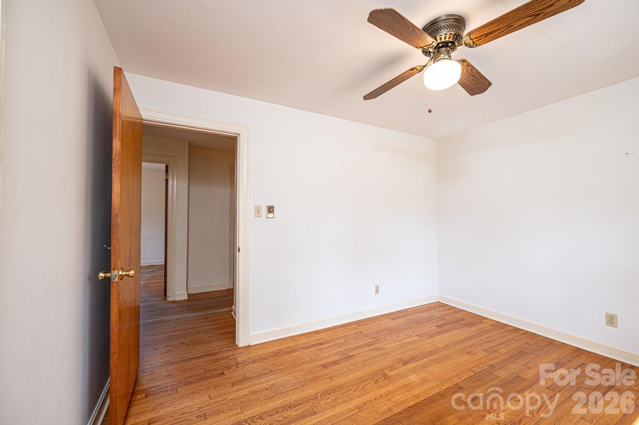 781 23rd Avenue Northeast Hickory, NC 28601 - Photo 34 of 41 an empty room with wooden floor fan and windows