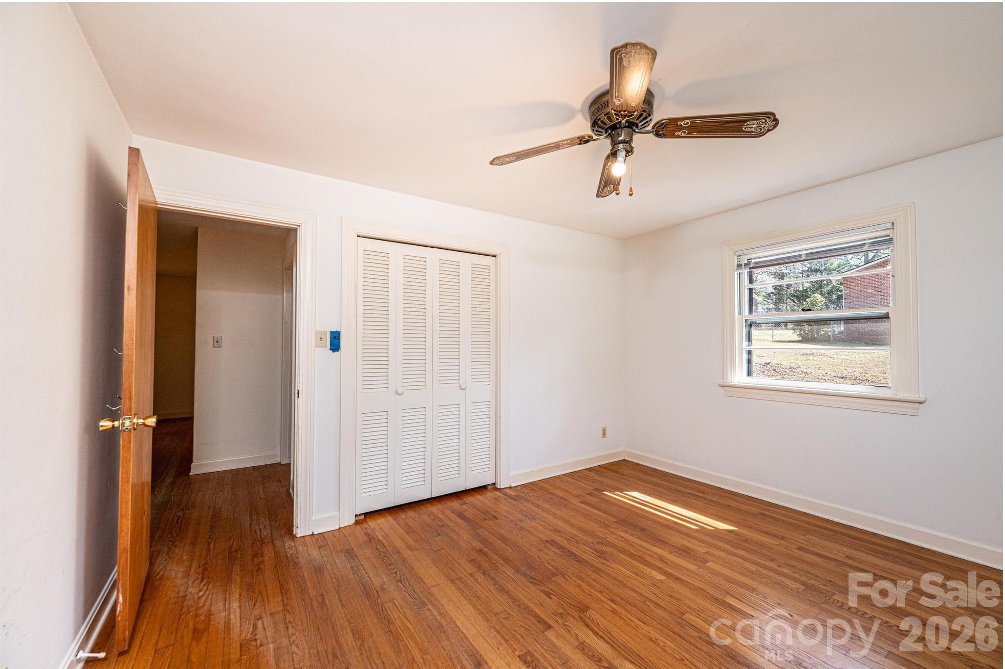 781 23rd Avenue Northeast Hickory, NC 28601 - Photo 38 of 41 an empty room with wooden floor chandelier fan and windows