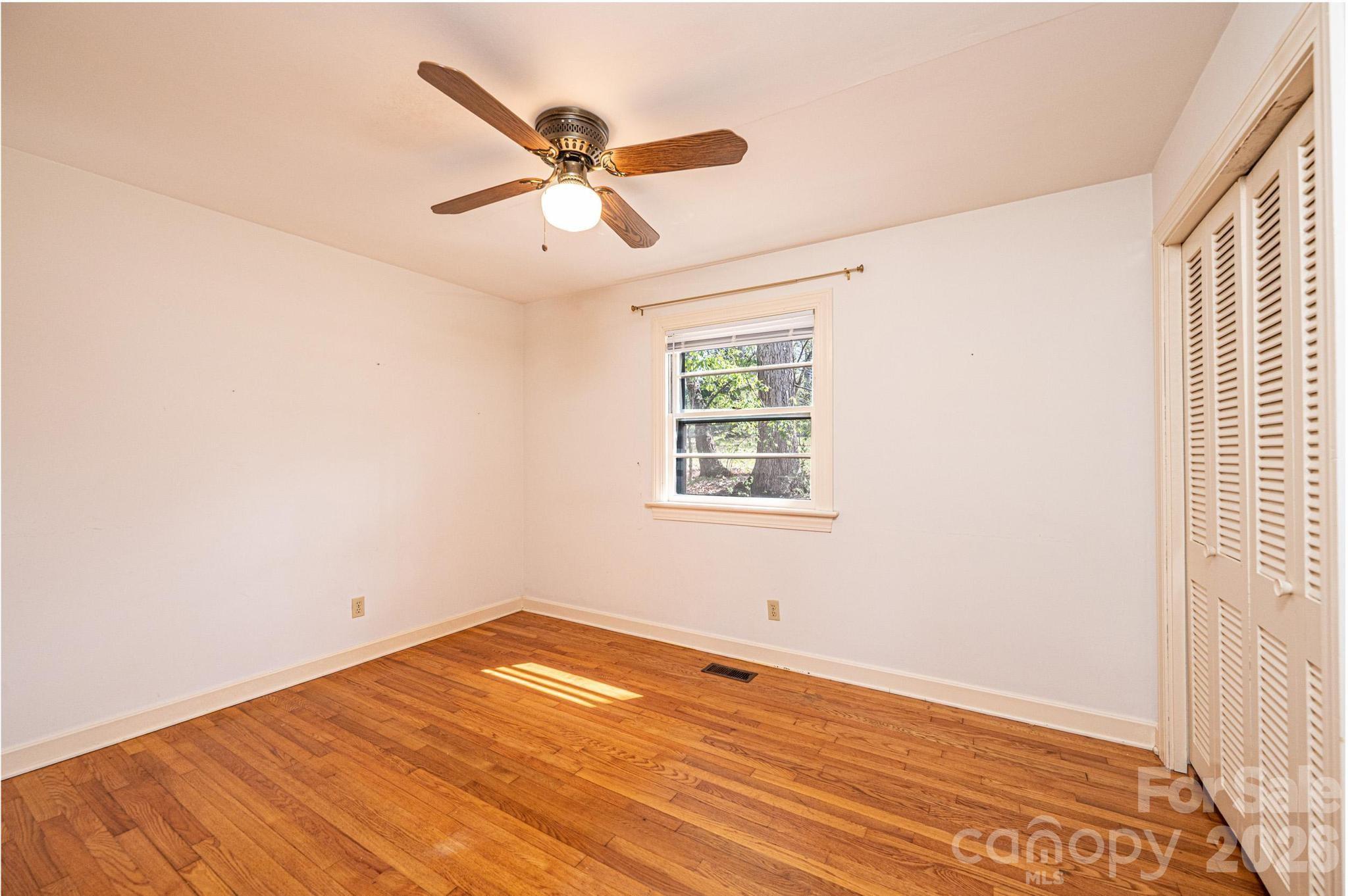 781 23rd Avenue Northeast Hickory, NC 28601 - Photo 39 of 41 an empty room with wooden floor fan and windows