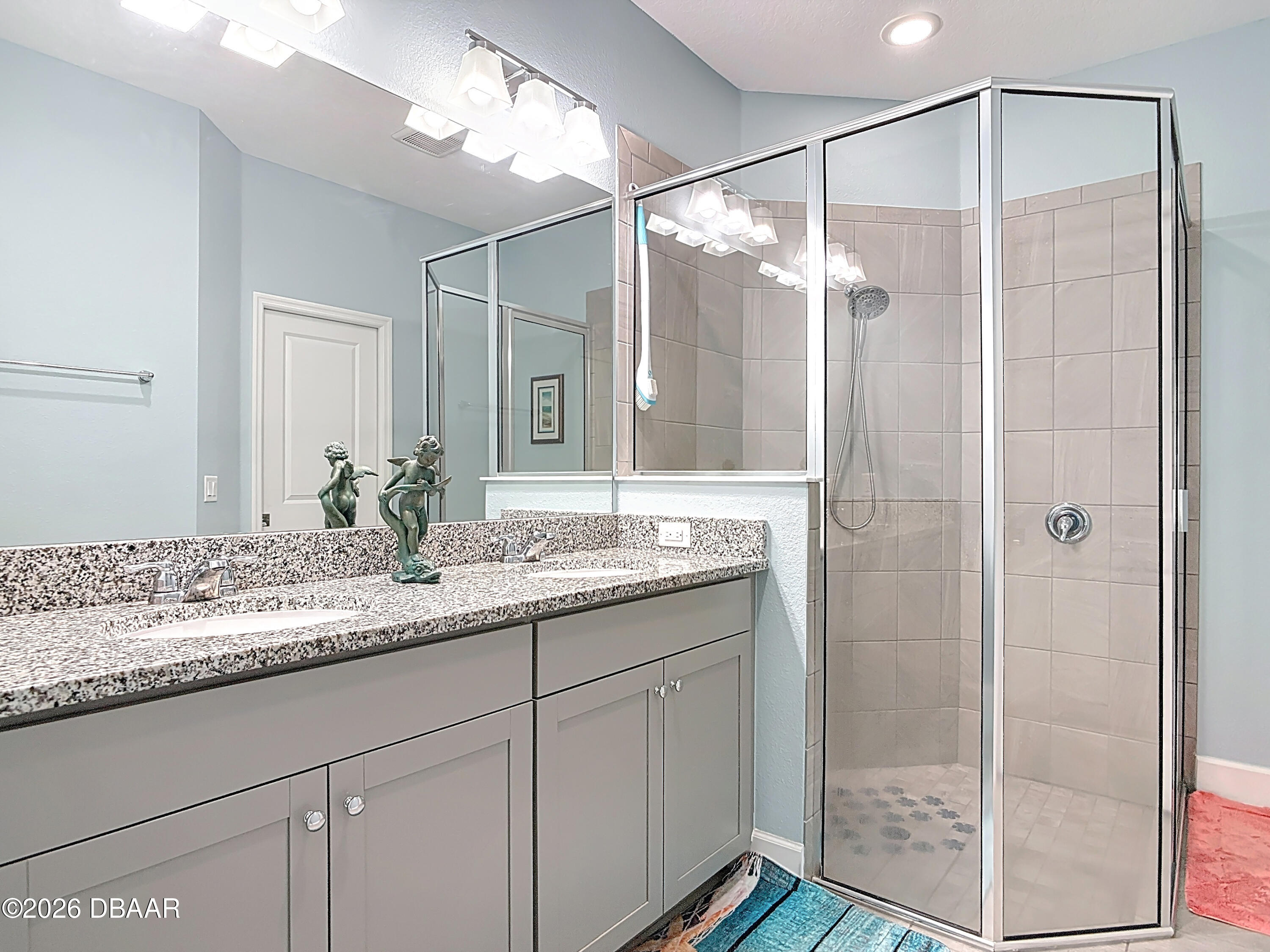 1002 Sea Shell Court Daytona Beach, FL 32124 - Photo 11 of 15 a bathroom with a granite countertop sink mirror and a shower