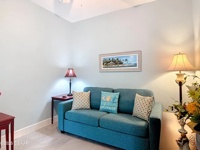 a living room with furniture and a lamp