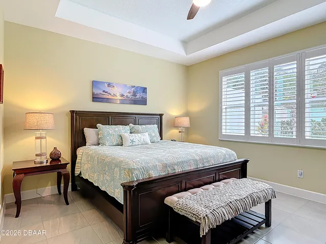 a bedroom with a bed and a night stand