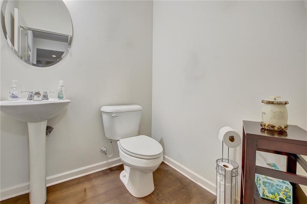 7687 Cabrini Place Fairburn, GA 30213 - Photo 11 of 29 a bathroom with a toilet sink and mirror