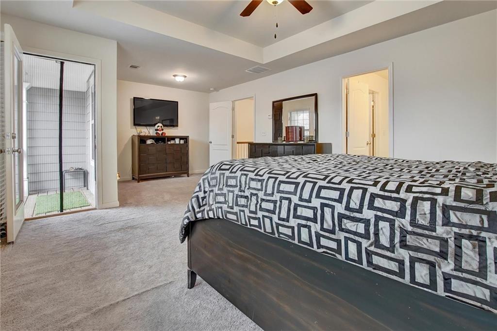 7687 Cabrini Place Fairburn, GA 30213 - Photo 17 of 29 a bedroom with a bed and a tv on table