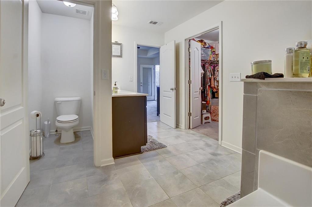 7687 Cabrini Place Fairburn, GA 30213 - Photo 22 of 29 a view of bathroom with a toilet sink and mirror
