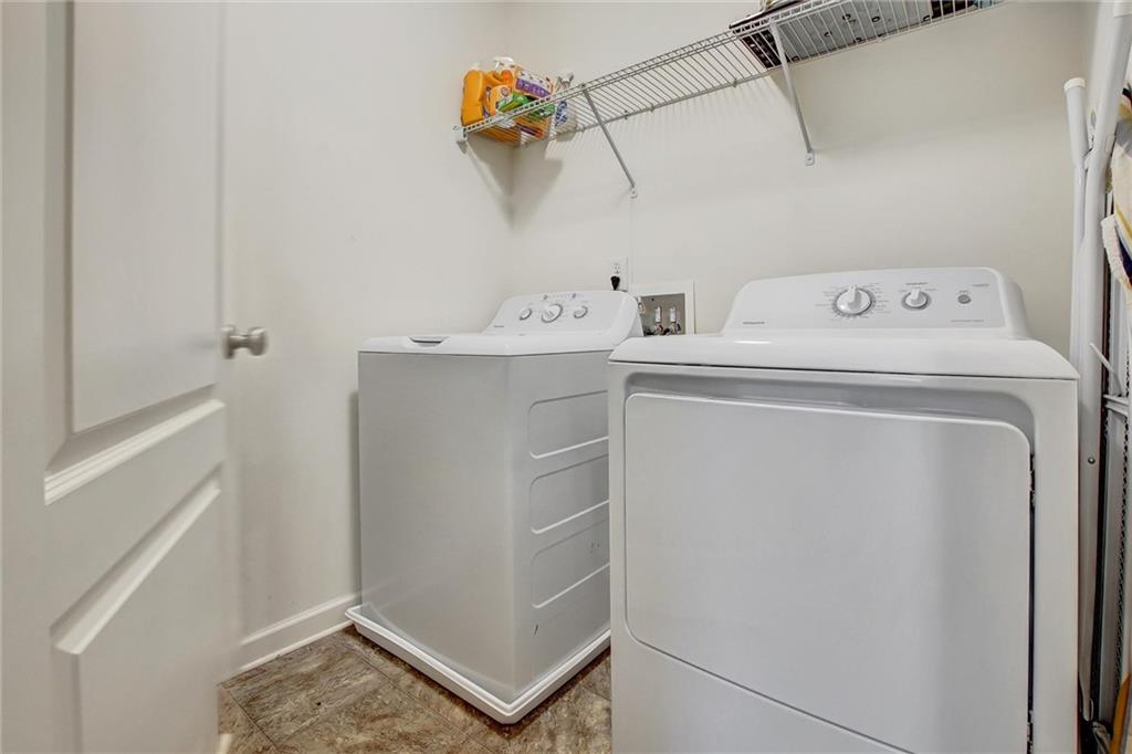7687 Cabrini Place Fairburn, GA 30213 - Photo 26 of 29 a utility room with dryer and washer
