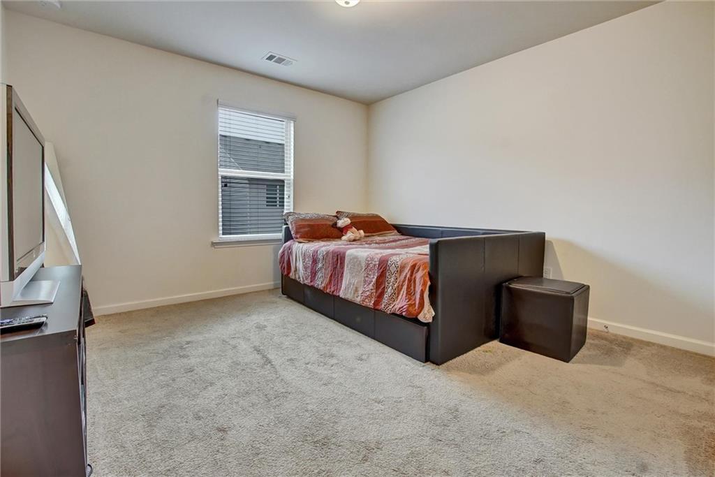 7687 Cabrini Place Fairburn, GA 30213 - Photo 28 of 29 a bedroom with a bed and window