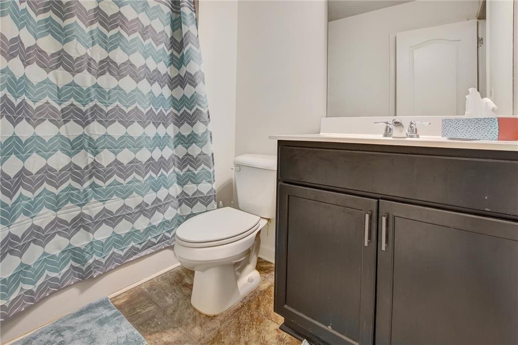 7687 Cabrini Place Fairburn, GA 30213 - Photo 29 of 29 a bathroom with a sink toilet and mirror